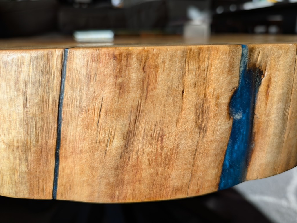 Close-up of live edge cottonwood with blue epoxy stabilization.