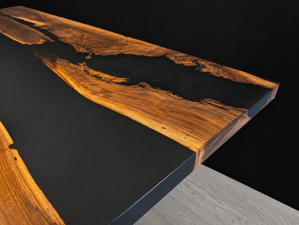 Close-up of figured black walnut grain on an adjacent-slab dining table.