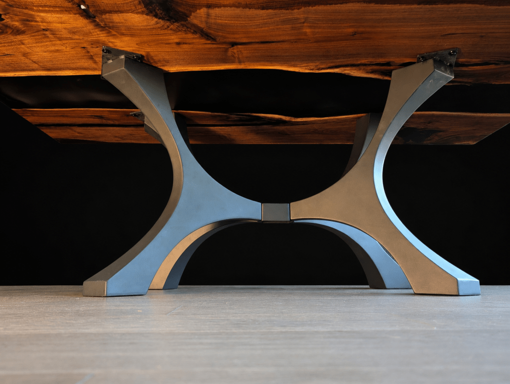 Powder-coated brushed steel pedestal base supporting an adjacent-slab black walnut dining table.